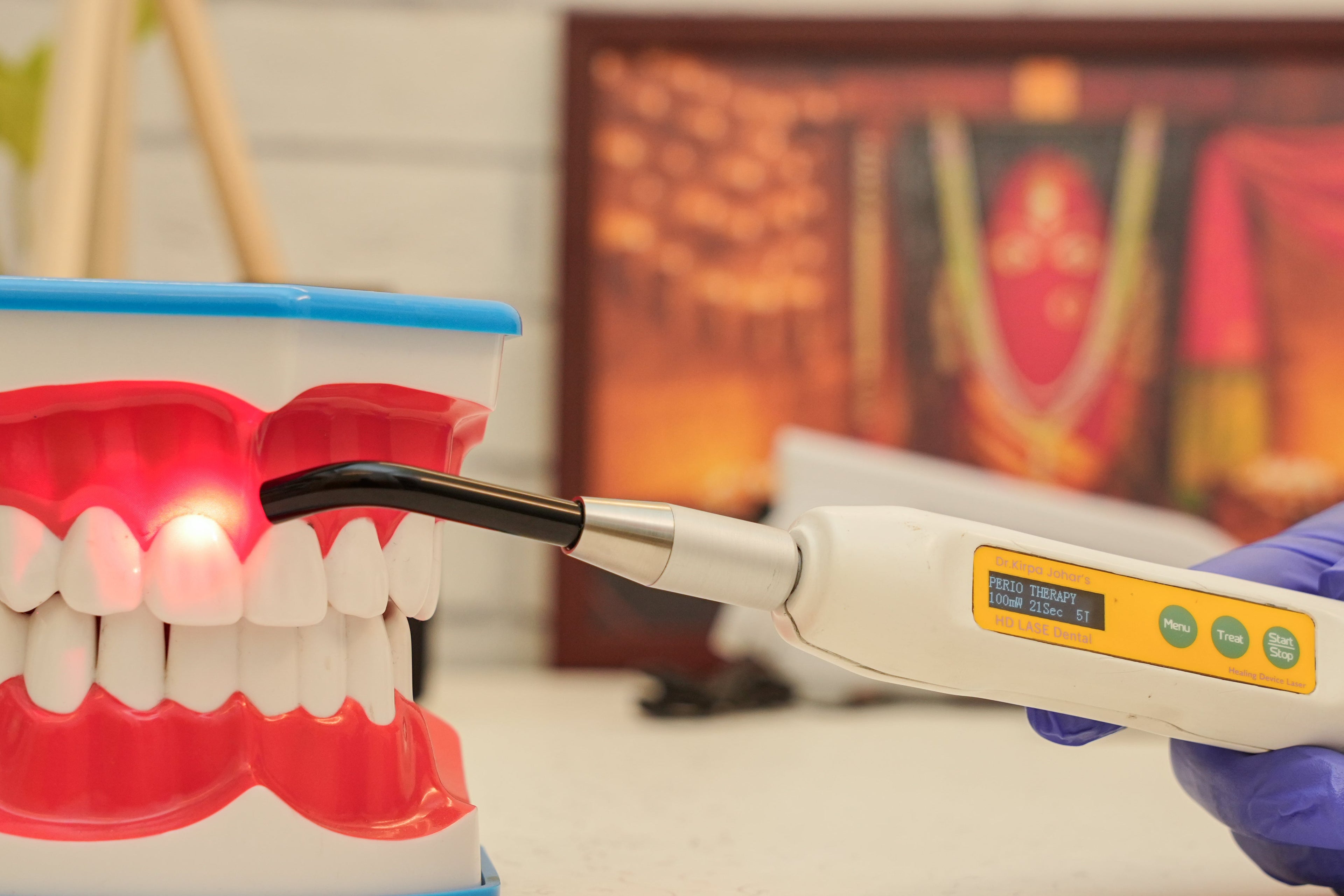 Dental tool being used on a model of teeth with a blurred background